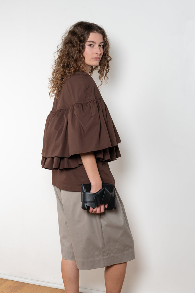 The Ruffle Tiered Top by Meryll Rogge is a crisp cotton top with layered ruffles that can be tucked into your trousers