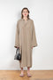 The 10.4 Dress by Monique Van Heist is a loose silk dress that can be tied at the waist