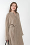 The 10.4 Dress by Monique Van Heist is a loose silk dress that can be tied at the waist
