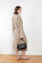The 10.4 Dress by Monique Van Heist is a loose silk dress that can be tied at the waist