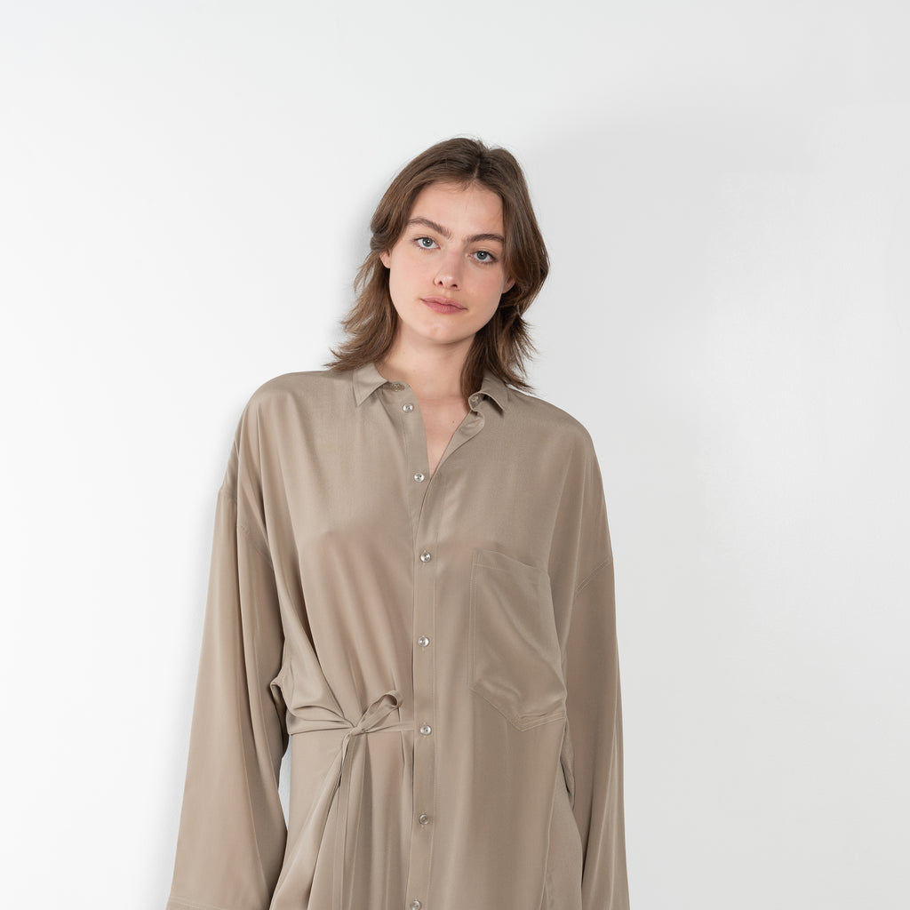 The 10.4 Dress by Monique Van Heist is a loose silk dress that can be tied at the waist
