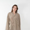 The 10.4 Dress by Monique Van Heist is a loose silk dress that can be tied at the waist