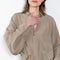 The 10.4 Dress by Monique Van Heist is a loose silk dress that can be tied at the waist