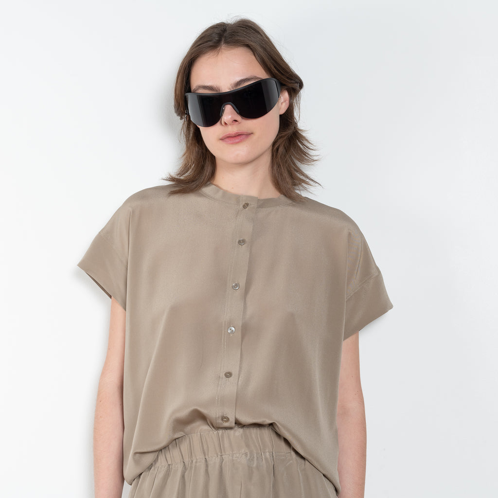 The Lily Top by Monique Van Heist is a short sleeved silk top with a buttoned mao collar