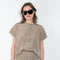 The Lily Top by Monique Van Heist is a short sleeved silk top with a buttoned mao collar