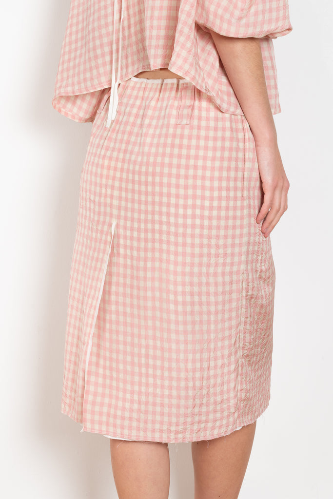 The Crayon Skirt by Nackiye is a knee length pencil skirt with loops. Gathered at the waist with a revealing petticoat