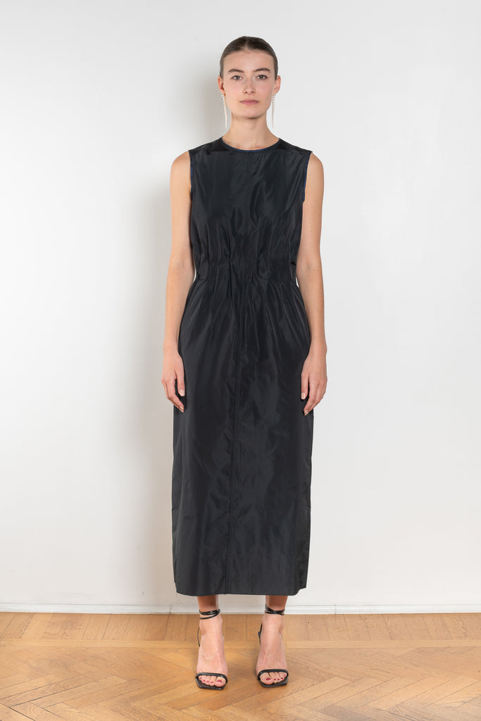 The Go Lightly Dress by Nackiye is a sleeveless ankle dress with exposed back and raw edging throughout