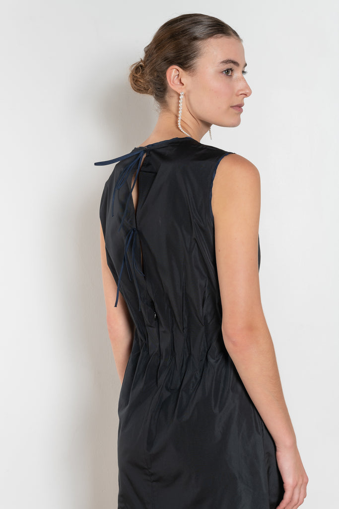 The Go Lightly Dress by Nackiye is a sleeveless ankle dress with exposed back and raw edging throughout