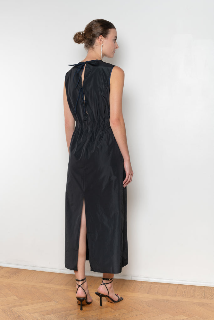 The Go Lightly Dress by Nackiye is a sleeveless ankle dress with exposed back and raw edging throughout