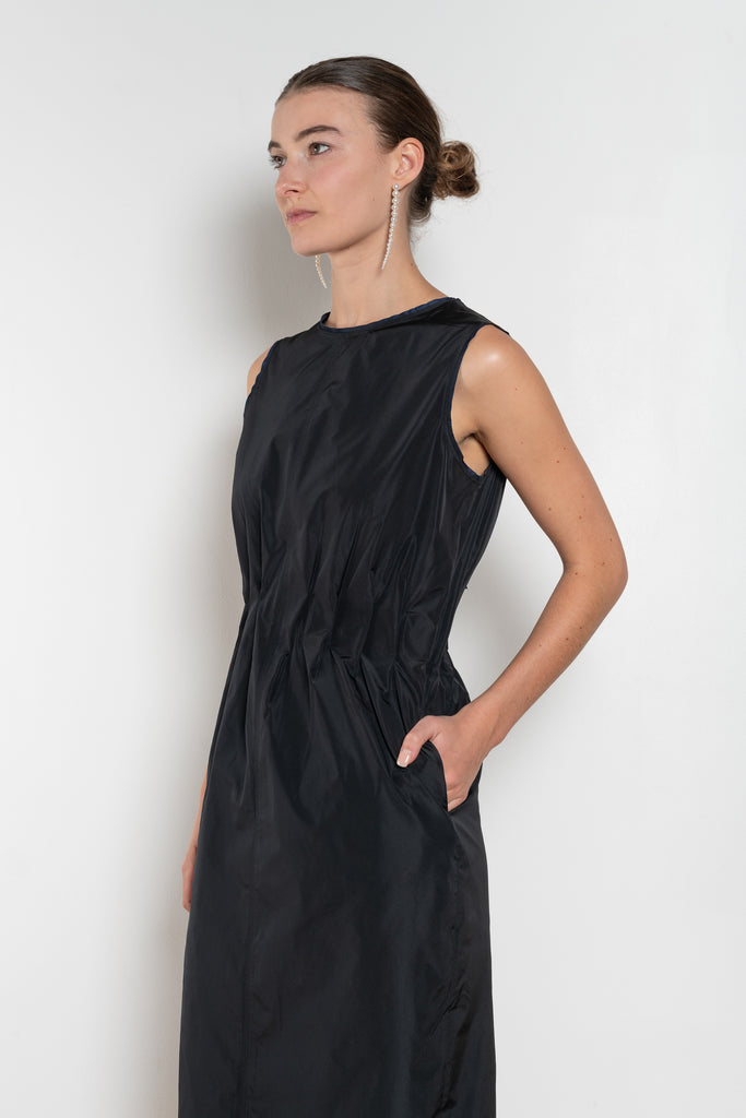 The Go Lightly Dress by Nackiye is a sleeveless ankle dress with exposed back and raw edging throughout