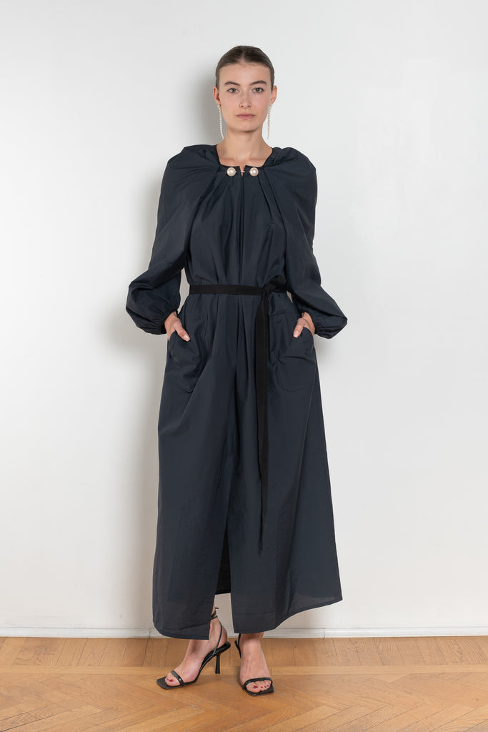 The Grand Bazaar Dress by Nackiye is a signature dress with shawl shoulder feature, two pockets, front slit and a belt, and the classic double pearl neck pin&nbsp;
