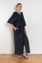 The Grand Bazaar Dress by Nackiye is a signature dress with shawl shoulder feature, two pockets, front slit and a belt, and the classic double pearl neck pin 