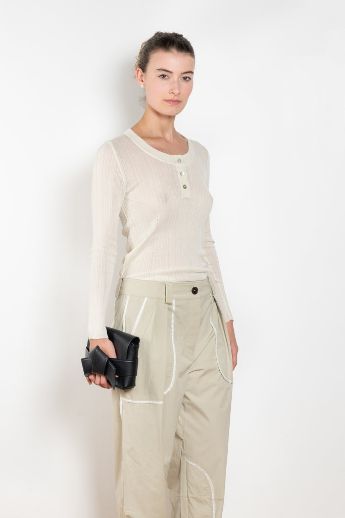 The Keep Close Top is a tightly ribbed buttoned Henley crew neck