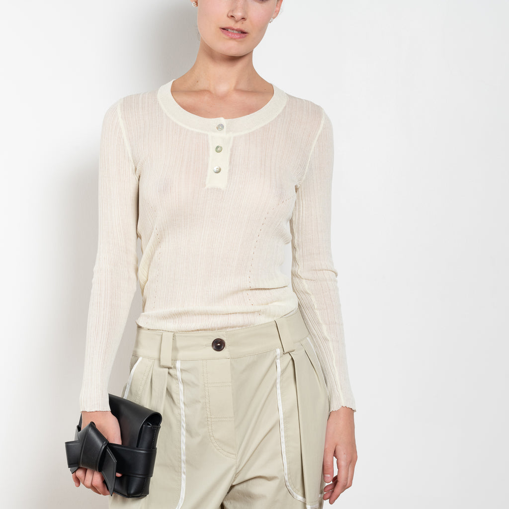 The Keep Close Top is a tightly ribbed buttoned Henley crew neck
