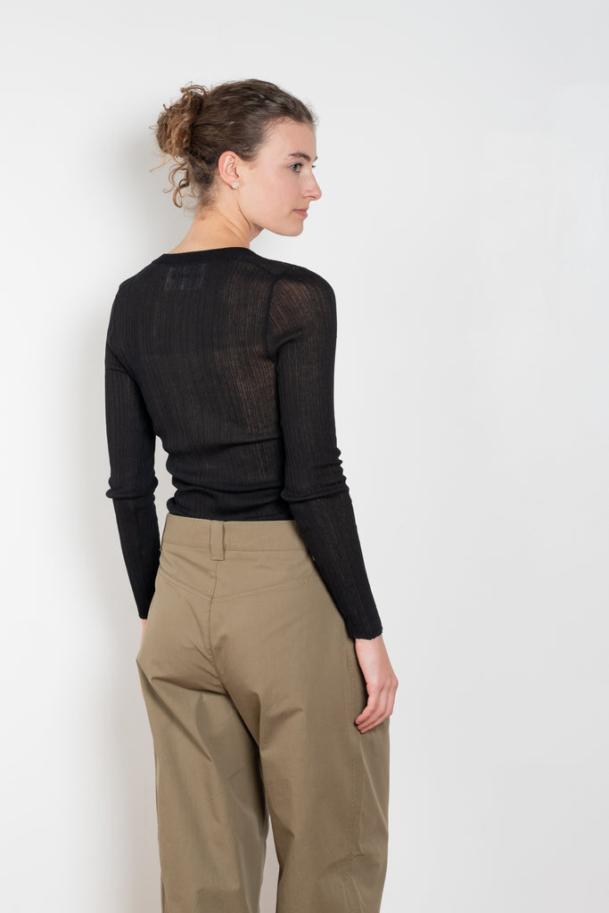 The Keep Close Top is a tightly ribbed buttoned Henley crew neck
