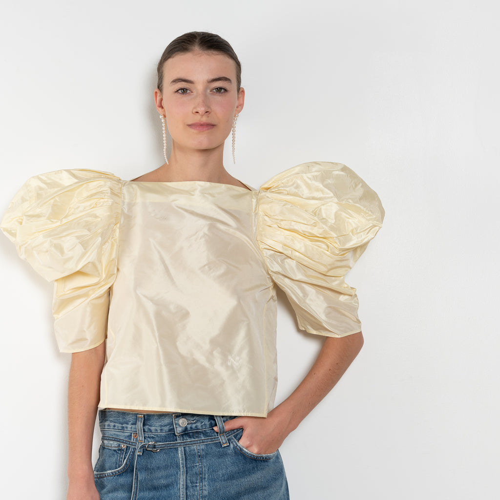 The Lolita Top by Nackiye has a boat neck, A-line silhouette and exaggerated scalloped sleeves