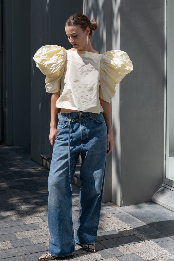 The Lolita Top by Nackiye has a boat neck, A-line silhouette and exaggerated scalloped sleeves