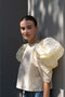 The Lolita Top by Nackiye has a boat neck, A-line silhouette and exaggerated scalloped sleeves