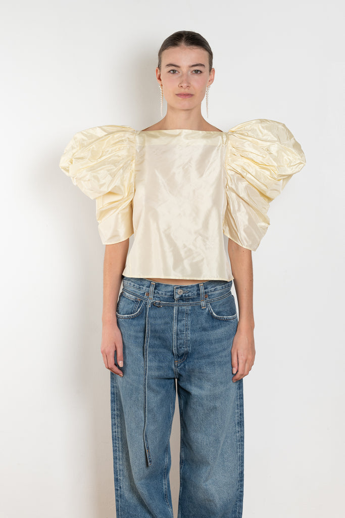 The Lolita Top by Nackiye has a boat neck, A-line silhouette and exaggerated scalloped sleeves