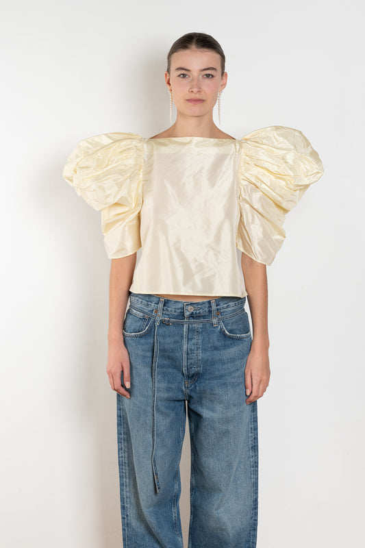 The Lolita Top by Nackiye has a boat neck, A-line silhouette and exaggerated scalloped sleeves