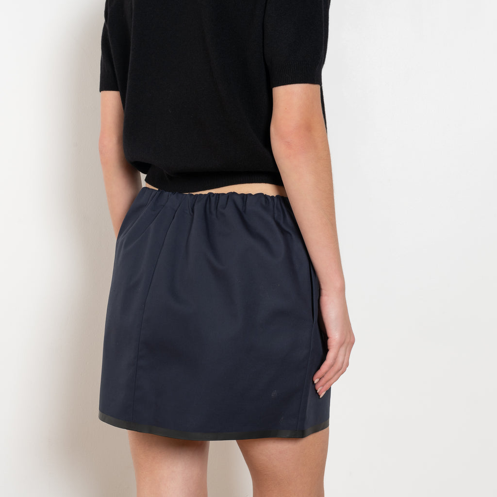 The Mini Skirt by Nackiye is gathered at the waist and featuring two side pockets, the little mini also has raw edging embellished with a rubber like piping