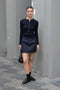 The Mini Skirt by Nackiye is gathered at the waist and featuring two side pockets, the little mini also has raw edging embellished with a rubber like piping