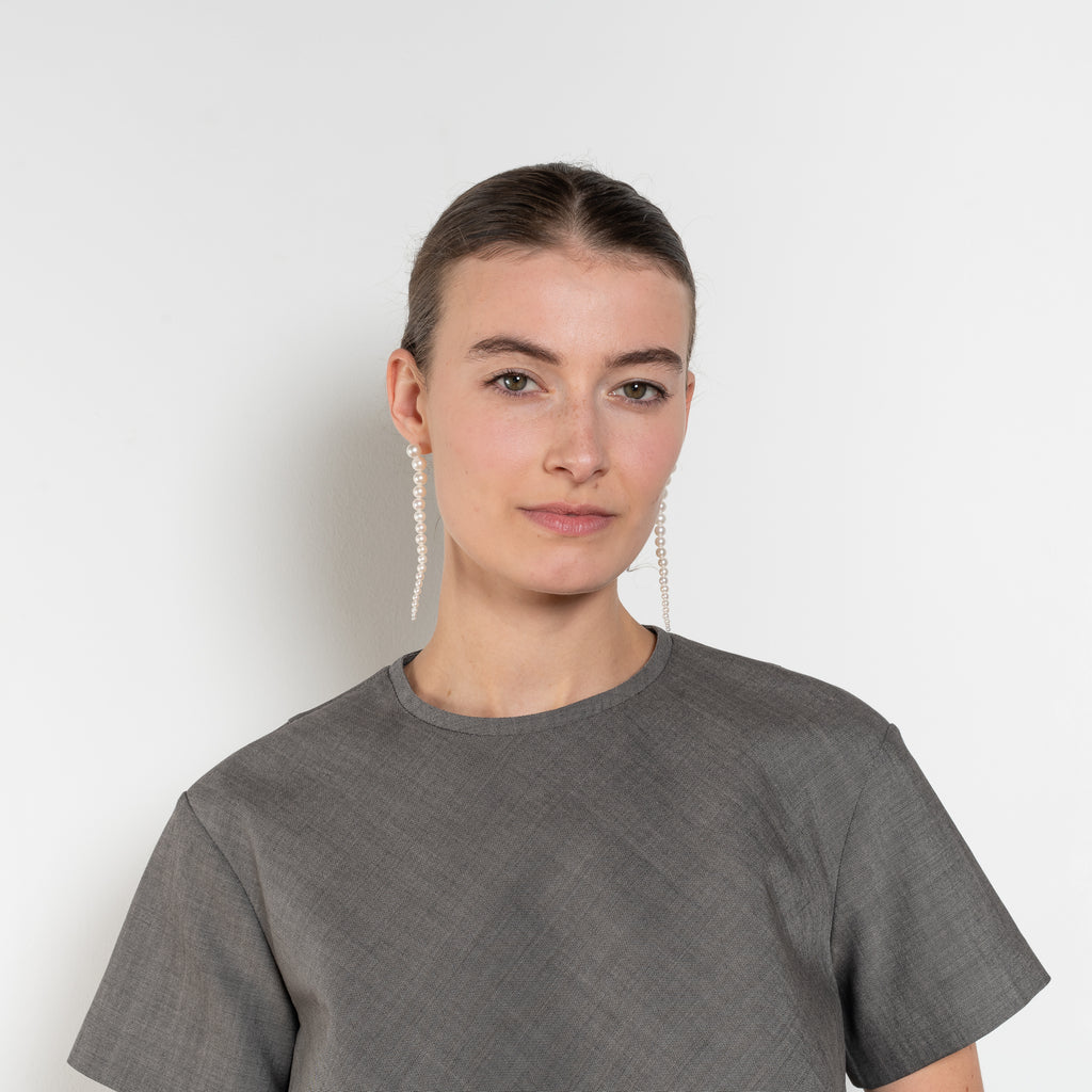The Pixie Top by Nackiye is a fresh take on the classic shirt. Sleek A-line silhouette, short sleeves & a detachable back belt