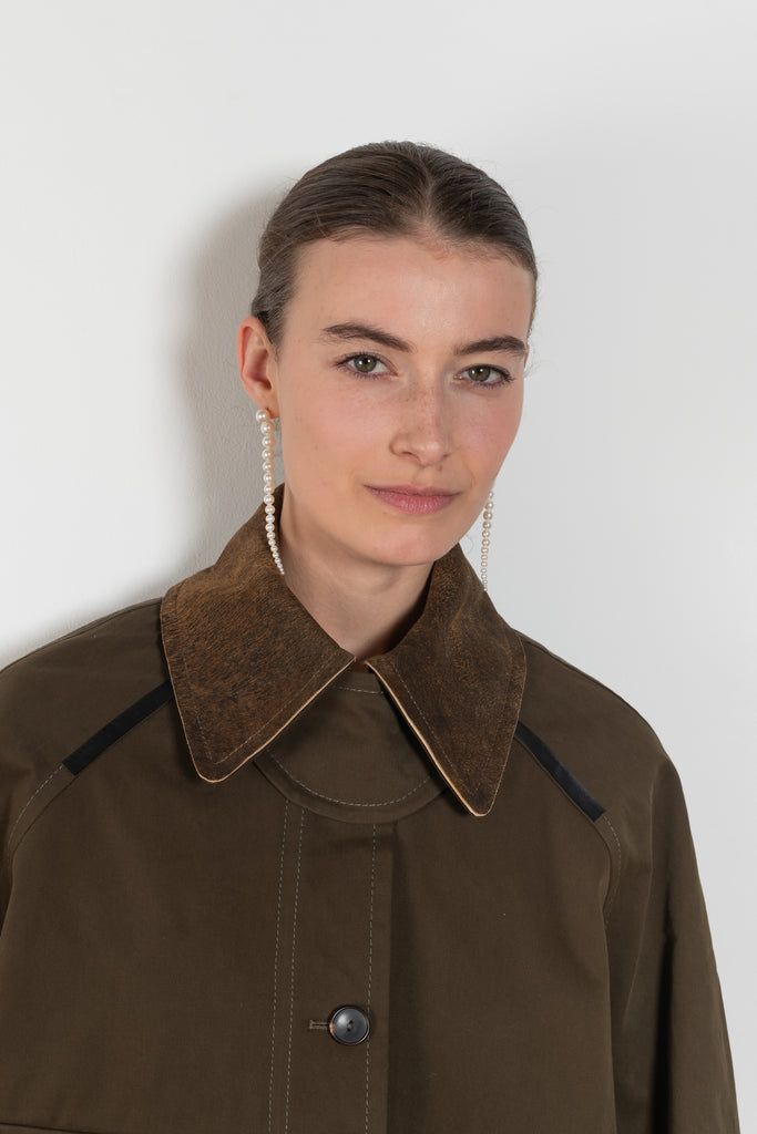 The Precious Cargo Jacket by Nackiye is a parka jacket with hand draped semi attached voluminous pockets and a leather collar