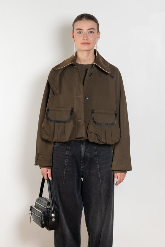 The Precious Cargo Jacket by Nackiye is a parka jacket with hand draped semi attached voluminous pockets and a leather collar
