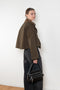 The Precious Cargo Jacket by Nackiye is a parka jacket with hand draped semi attached voluminous pockets and a leather collar