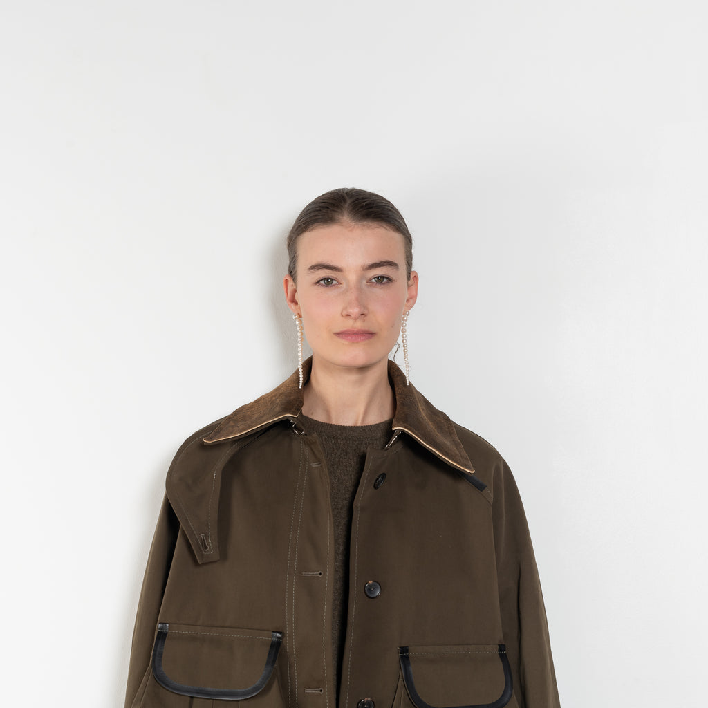 The Precious Cargo Jacket by Nackiye is a parka jacket with hand draped semi attached voluminous pockets and a leather collar