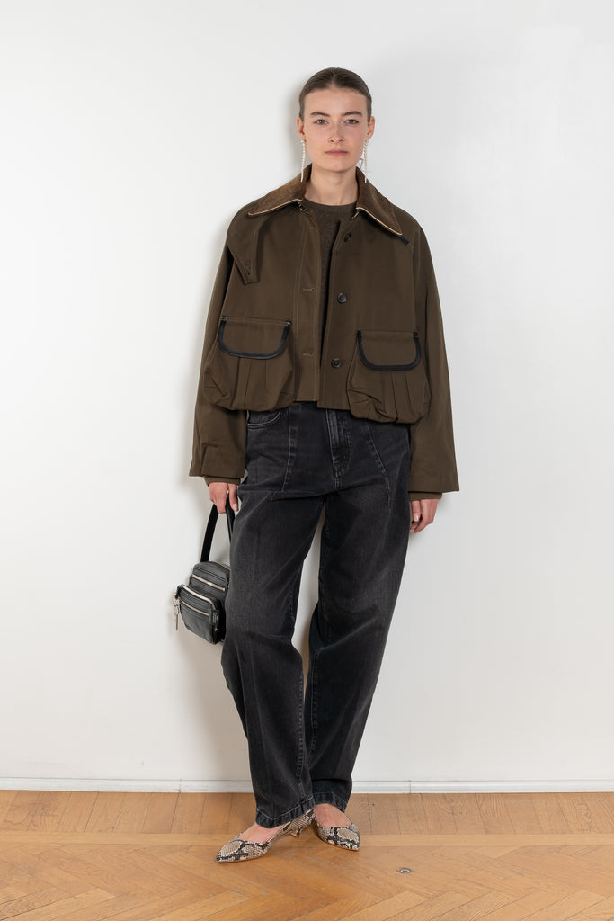 The Precious Cargo Jacket by Nackiye is a parka jacket with hand draped semi attached voluminous pockets and a leather collar
