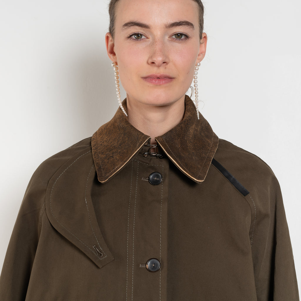 The Precious Cargo Jacket by Nackiye is a parka jacket with hand draped semi attached voluminous pockets and a leather collar