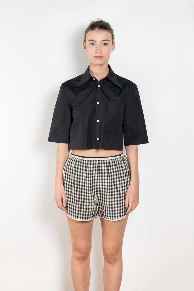 The Shortcut Shirt by Nackiye is a crop shirt with pointy collar and faux front pockets