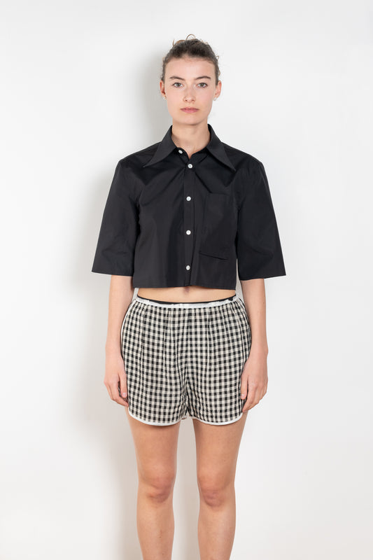 The Shortcut Shirt by Nackiye is a crop shirt with pointy collar and faux front pockets