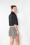 The Shortcut Shirt by Nackiye is a crop shirt with pointy collar and faux front pockets