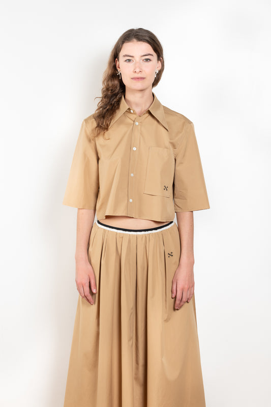 The Shortcut Shirt by Nackiye is a crop shirt with pointy collar and faux front pockets. 
