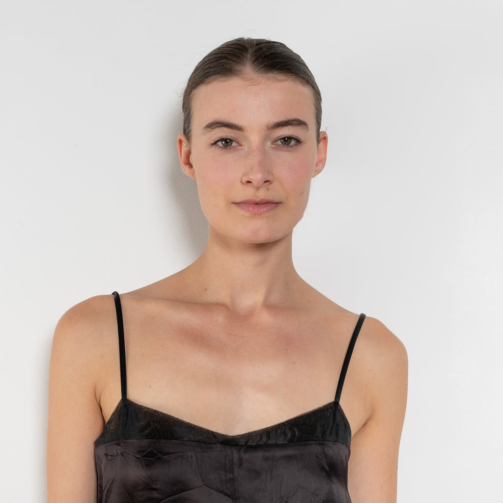 The Little Black Dress by Nackiye is a delicate slip dress with a gathered waist and mesh details