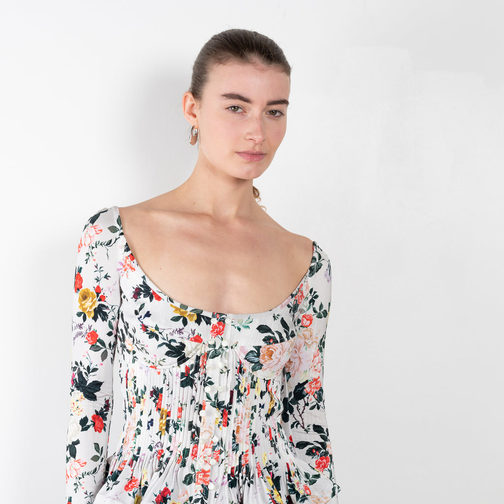 The Floral Peplum Top by Paco Rabanne is a floral top with a bustier upper and peplum details