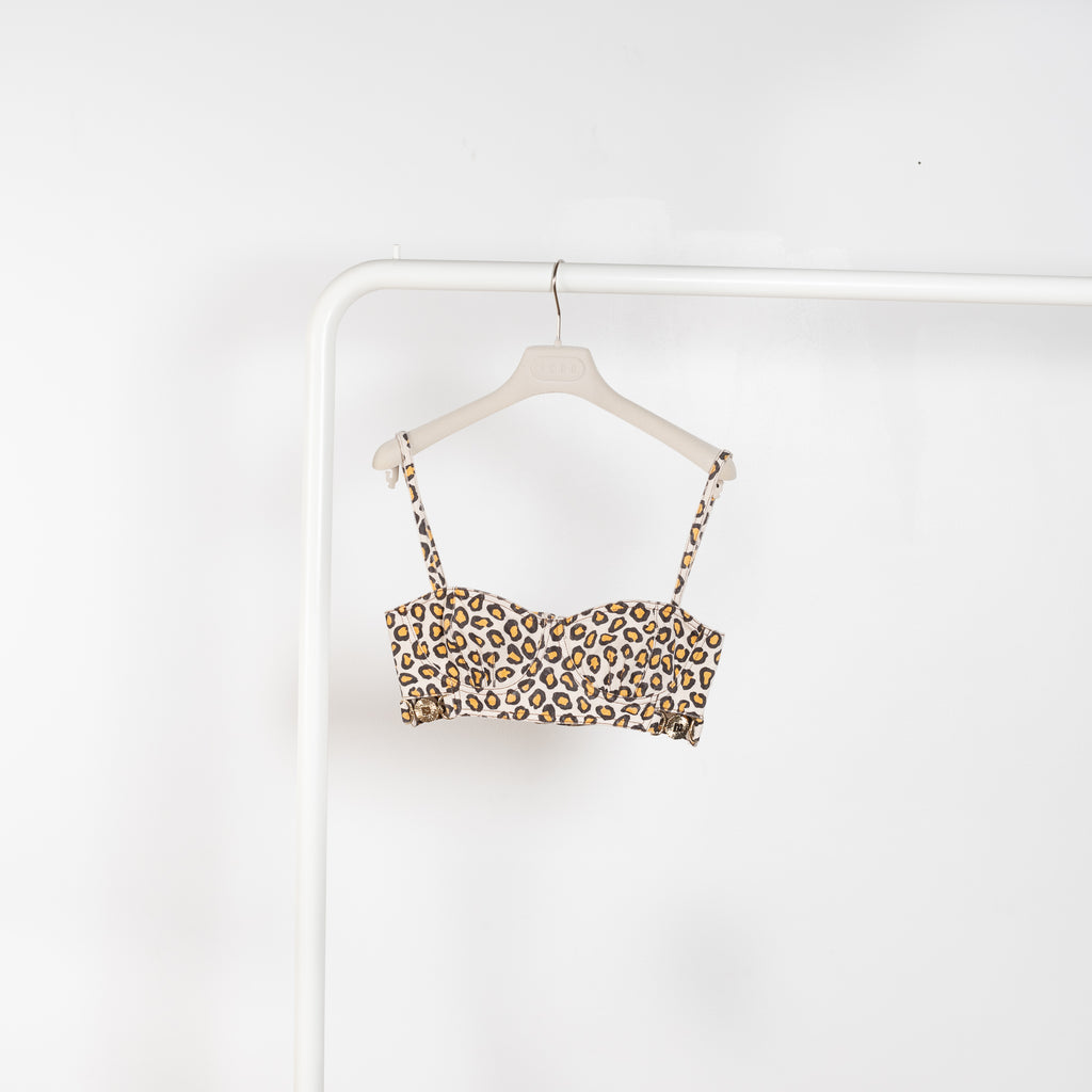 The Bralette Top by Paco Rabanne is a denim bralette with embellished PR details in a leopard print
