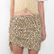 The Leopard Skirt by Paco Rabanne is a mini skirt with adjustable press buttons in a leopard print