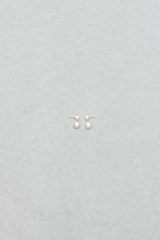The Venus D'Eau Earrings by Sophie Bille Brahe is a petite pair of pearl earrings featuring a delicate drop shaped pearl dangling from the ear