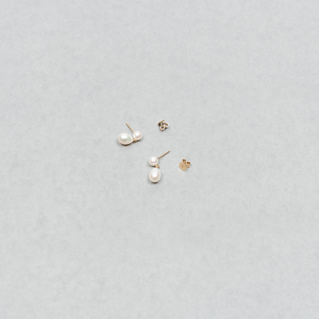 The Venus D'Eau Earrings by Sophie Bille Brahe is a petite pair of pearl earrings featuring a delicate drop shaped pearl dangling from the ear