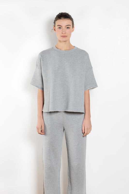 The Romeo Sweatshirt by Xirena is a soft fleece sweater with short sleeves in a slight cropped fit with a raw cut hem
