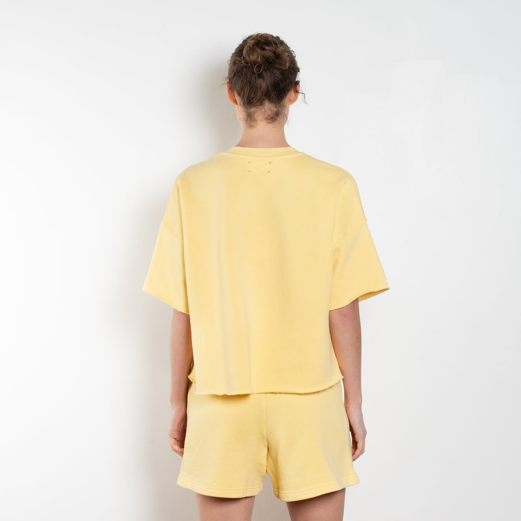 The Romeo Sweatshirt by Xirena is a soft fleece sweater with short sleeves in a slight cropped fit with a raw cut hem