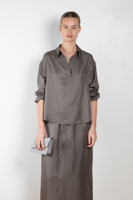 The Gathered Polo Top by 6397 is a flowy top with a polo collar and pleats for added volume on the back