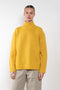 The Everyday Mockneck Sweater by 6397 is a oversized loose knitted sweater in a warm yellow with a high mock neck