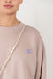 The Face Sweater 156 by Acne Studios is an oversized crew neck sweater with a face logo patch on the chest and ribbed cuffs and hem
