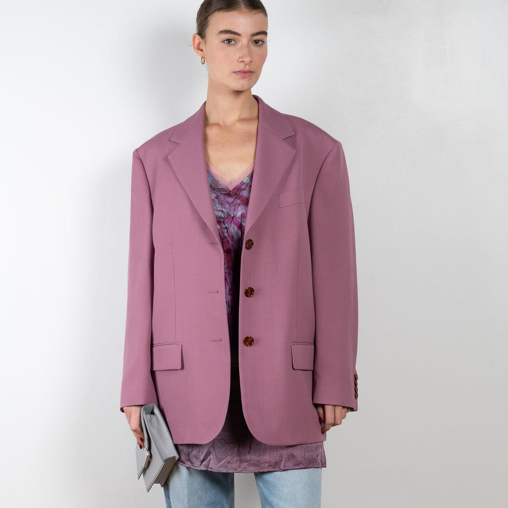 The Tailored Suit Jacket 410 by Acne Studios is a single-breasted wool blend blazer cut to a relaxed silhouette with tailored shoulder pads