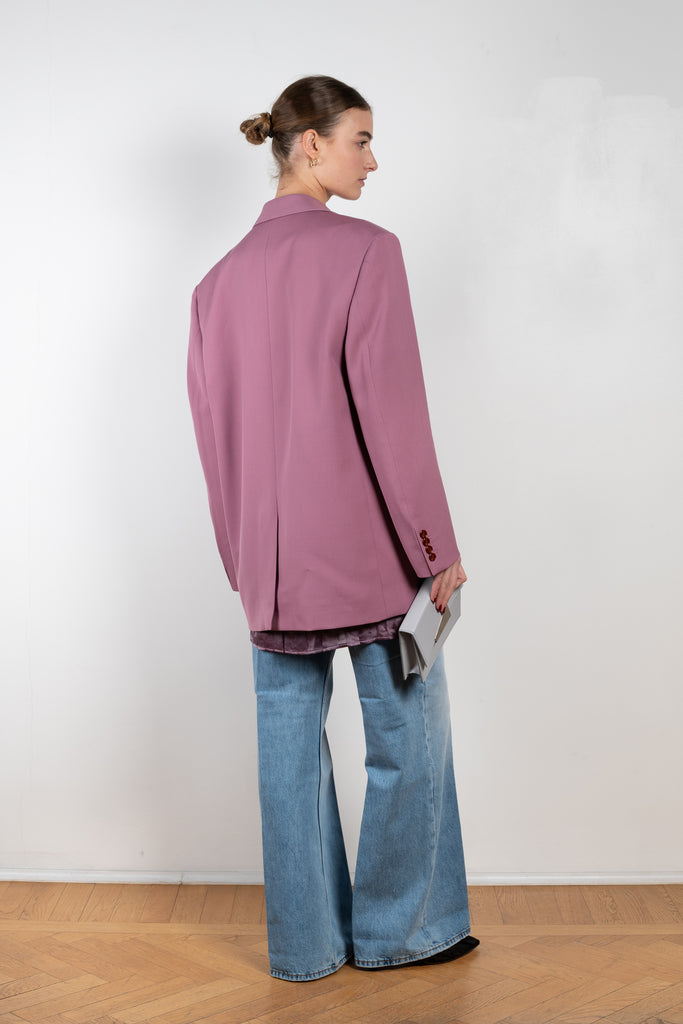 The Tailored Suit Jacket 410 by Acne Studios is a single-breasted wool blend blazer cut to a relaxed silhouette with tailored shoulder pads